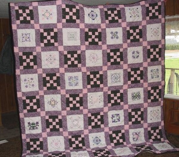 Irish Chain quilt with Anemone designs by Catherine